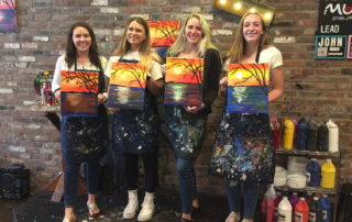 Bar Louie employees enjoy a complimentary painting session at Muse Paintbar during Wellness Week.